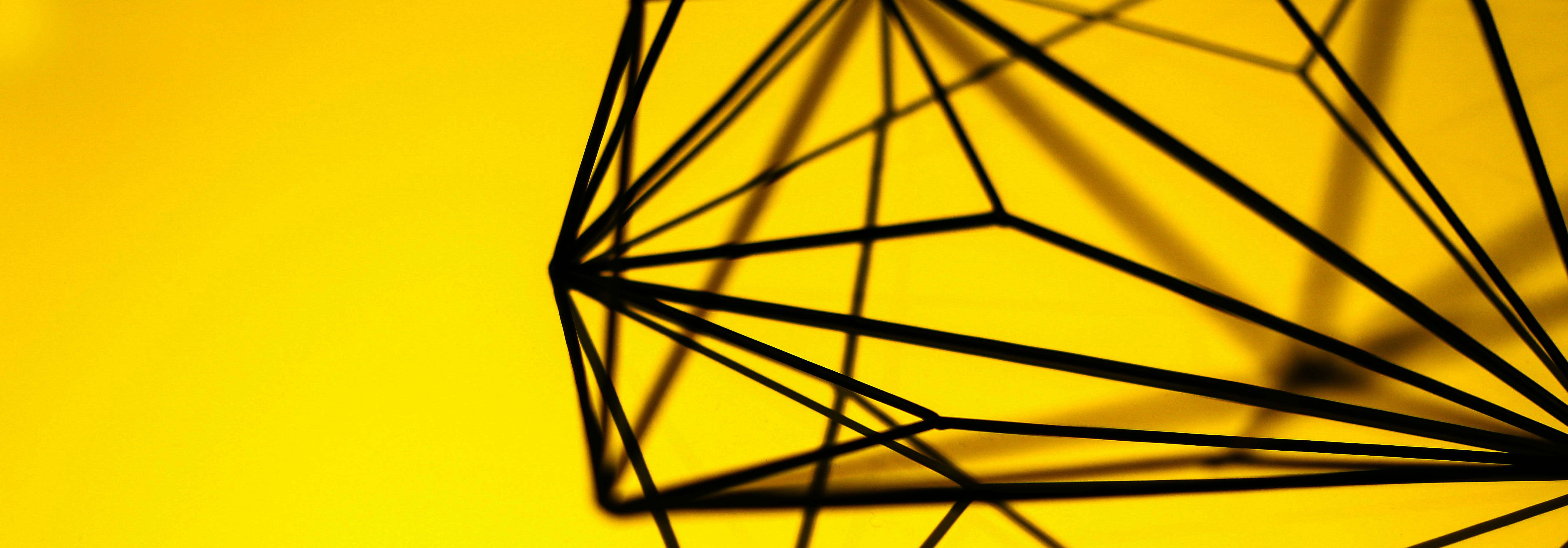 black geometric shapes on a yellow background